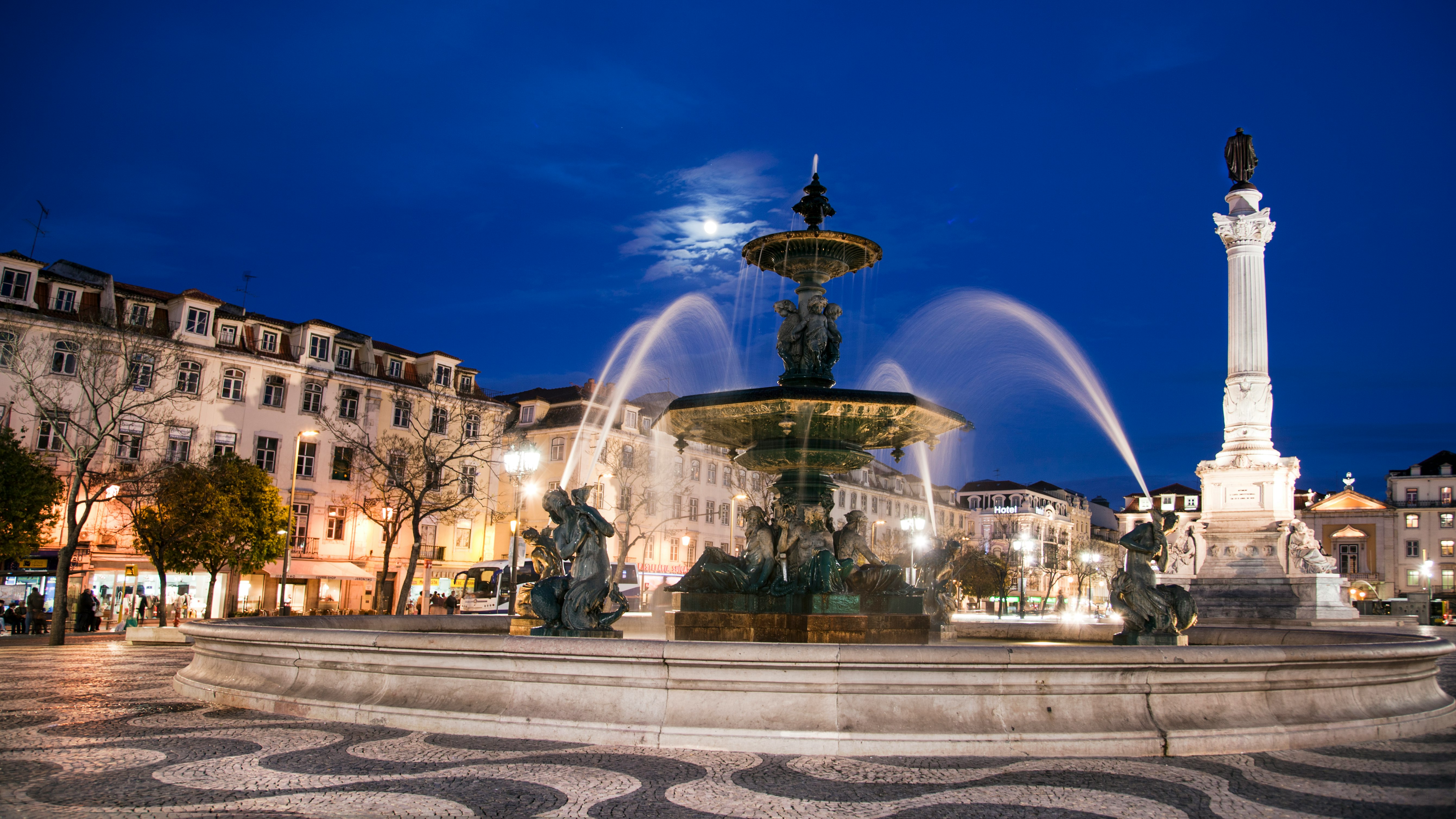 water fountain in the middle of the city during night time